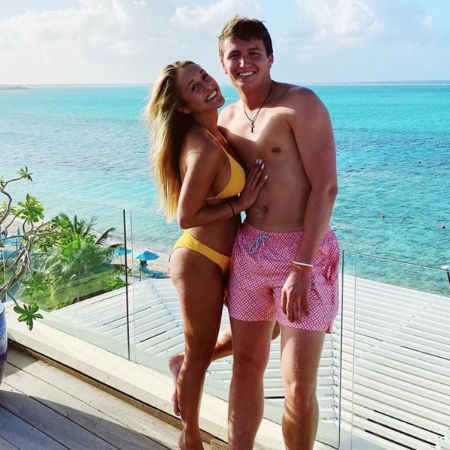 Drew Lock and his girlfriend pose besides the sea.